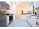 Bright kitchen featuring stainless steel appliances and white shaker cabinets at 3111 Arrowsmith Rd, Wimauma, FL 33598