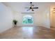 Bright and airy living room with a large window and tile floors at 3111 Arrowsmith Rd, Wimauma, FL 33598