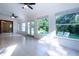 Spacious sunroom with large windows, tile floors, and ceiling fans at 3111 Arrowsmith Rd, Wimauma, FL 33598