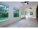 Sunroom featuring tile floors, multiple windows, and ceiling fan at 3111 Arrowsmith Rd, Wimauma, FL 33598