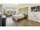 Spacious Primary bedroom with a king-size bed and sitting area at 30425 Pecan Valley Loop, Wesley Chapel, FL 33543