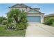 Two story house with landscaped yard and driveway at 30425 Pecan Valley Loop, Wesley Chapel, FL 33543
