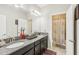 Bathroom with double vanity, granite countertop, and separate shower at 30425 Pecan Valley Loop, Wesley Chapel, FL 33543