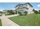 Two-story house with a landscaped yard and a two-car garage at 30425 Pecan Valley Loop, Wesley Chapel, FL 33543