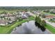 Aerial view of a beautiful community with a lake, houses, and green spaces at 30425 Pecan Valley Loop, Wesley Chapel, FL 33543