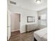 Bedroom with dresser, mirror, and access to hallway at 30425 Pecan Valley Loop, Wesley Chapel, FL 33543