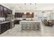 Modern kitchen with island, stainless steel appliances, and dark wood cabinets at 30425 Pecan Valley Loop, Wesley Chapel, FL 33543