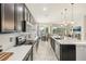 Open kitchen with large island, stainless steel appliances, and white countertops at 30425 Pecan Valley Loop, Wesley Chapel, FL 33543