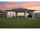 Covered patio with seating area and grill at 30425 Pecan Valley Loop, Wesley Chapel, FL 33543