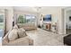 Spacious living room with large windows, comfortable seating, and a large TV at 30425 Pecan Valley Loop, Wesley Chapel, FL 33543