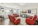 Game room with red reclining chairs and a large TV at 30425 Pecan Valley Loop, Wesley Chapel, FL 33543