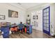 Home office with a large blue desk and hardwood floors, French doors leading to another room at 30425 Pecan Valley Loop, Wesley Chapel, FL 33543