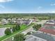 Aerial view of a residential neighborhood with houses, a lake, and lush greenery at 30425 Pecan Valley Loop, Wesley Chapel, FL 33543