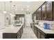 Modern kitchen with large island, stainless steel appliances, and dark wood cabinets at 30425 Pecan Valley Loop, Wesley Chapel, FL 33543