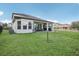 Spacious backyard with a large grassy area and a covered patio at 30425 Pecan Valley Loop, Wesley Chapel, FL 33543