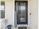 Elegant front door with glass panels and a welcome sign at 30425 Pecan Valley Loop, Wesley Chapel, FL 33543