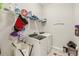 Bright laundry room with washer, dryer, and ample shelving at 30425 Pecan Valley Loop, Wesley Chapel, FL 33543