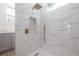 Walk-in shower with marble tile and gold fixtures at 13049 Thoroughbred Dr, Dade City, FL 33525