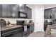 Close-up of modern kitchen details featuring granite countertops, black appliances, and dark cabinetry at 11638 Cambium Crown Dr, Riverview, FL 33569