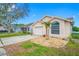 One-story home with a driveway, attached garage, and landscaping at 11639 Sunshine Pond Rd, Tampa, FL 33635