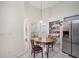 Cozy kitchen nook with built-in shelving and a stainless steel refrigerator at 11639 Sunshine Pond Rd, Tampa, FL 33635