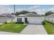 One-story house with attached garage and front yard at 7864 Broad Pointe Dr, Zephyrhills, FL 33540