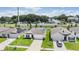 Aerial view of three houses with solar panels and driveways at 7864 Broad Pointe Dr, Zephyrhills, FL 33540