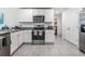 Modern kitchen with stainless steel appliances and granite countertops at 7864 Broad Pointe Dr, Zephyrhills, FL 33540