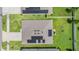 Aerial view of house with solar panels and grassy backyard at 7864 Broad Pointe Dr, Zephyrhills, FL 33540