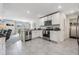 Open concept kitchen with island and view into living room at 7864 Broad Pointe Dr, Zephyrhills, FL 33540