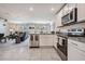Open concept kitchen with island and view into living room at 7864 Broad Pointe Dr, Zephyrhills, FL 33540