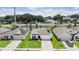 Aerial view of three houses with solar panels and driveways at 7864 Broad Pointe Dr, Zephyrhills, FL 33540