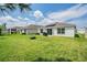 Backyard with grassy lawn and patio at 7864 Broad Pointe Dr, Zephyrhills, FL 33540