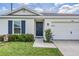 House exterior featuring a front door and attached garage at 7864 Broad Pointe Dr, Zephyrhills, FL 33540