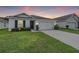 One-story house with attached garage and landscaped lawn at 7864 Broad Pointe Dr, Zephyrhills, FL 33540