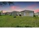 Spacious backyard with a large lawn and grill area at 7864 Broad Pointe Dr, Zephyrhills, FL 33540
