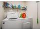 Convenient laundry room with washer, dryer, and storage at 7864 Broad Pointe Dr, Zephyrhills, FL 33540