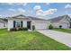 One-story house with a two-car garage and neat lawn at 7864 Broad Pointe Dr, Zephyrhills, FL 33540