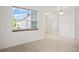 Bright dining room with large window and view of the kitchen at 4906 Avila Lakes Dr, Wimauma, FL 33598