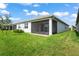 Home with screened patio and grassy backyard at 4906 Avila Lakes Dr, Wimauma, FL 33598