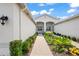 Inviting entryway with a brick walkway and lush landscaping at 4906 Avila Lakes Dr, Wimauma, FL 33598