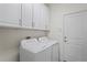 Laundry room with washer, dryer, and cabinets at 4906 Avila Lakes Dr, Wimauma, FL 33598