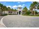 Valencia Del Sol clubhouse entrance with palm trees at 4906 Avila Lakes Dr, Wimauma, FL 33598