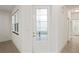 Bright entryway with a modern front door and tile floors at 4906 Avila Lakes Dr, Wimauma, FL 33598