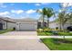 Beautiful one-story home with a two-car garage and landscaped yard at 4906 Avila Lakes Dr, Wimauma, FL 33598