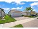 Two-car garage with paver driveway and landscaping at 4906 Avila Lakes Dr, Wimauma, FL 33598