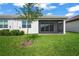 Home with screened patio and grassy backyard at 4906 Avila Lakes Dr, Wimauma, FL 33598