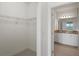 Walk-in closet with wire shelving and bathroom access at 4906 Avila Lakes Dr, Wimauma, FL 33598