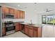 Kitchen features stainless steel appliances and a view of the backyard at 4906 Avila Lakes Dr, Wimauma, FL 33598