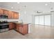 Kitchen with island, stainless steel appliances, and access to living area at 4906 Avila Lakes Dr, Wimauma, FL 33598